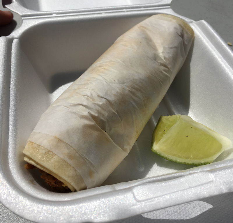 Boni's serves their tacos rolled up in waxed paper
