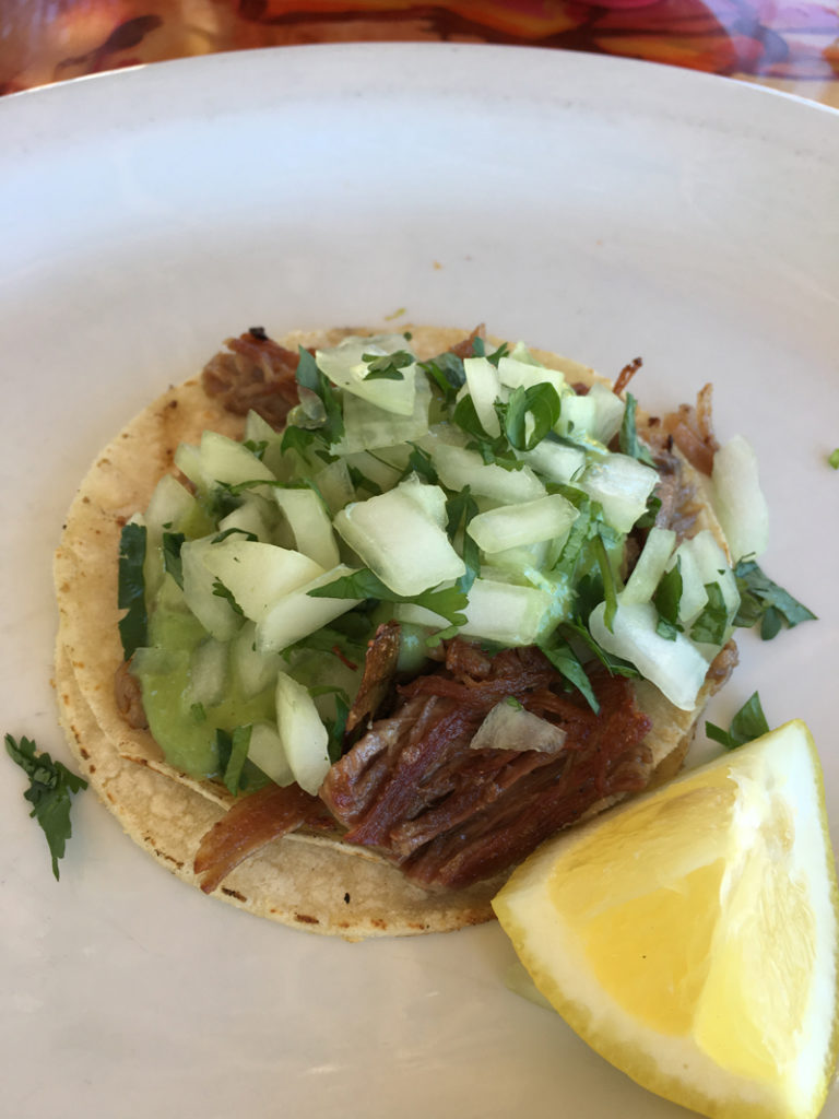 Taco Mafia's carnitas taco is a classic street food-style taco, served on two small corn tortillas.
