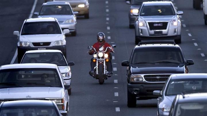 A motorcyclist splits lanes in California, the only state where it is currently legal.