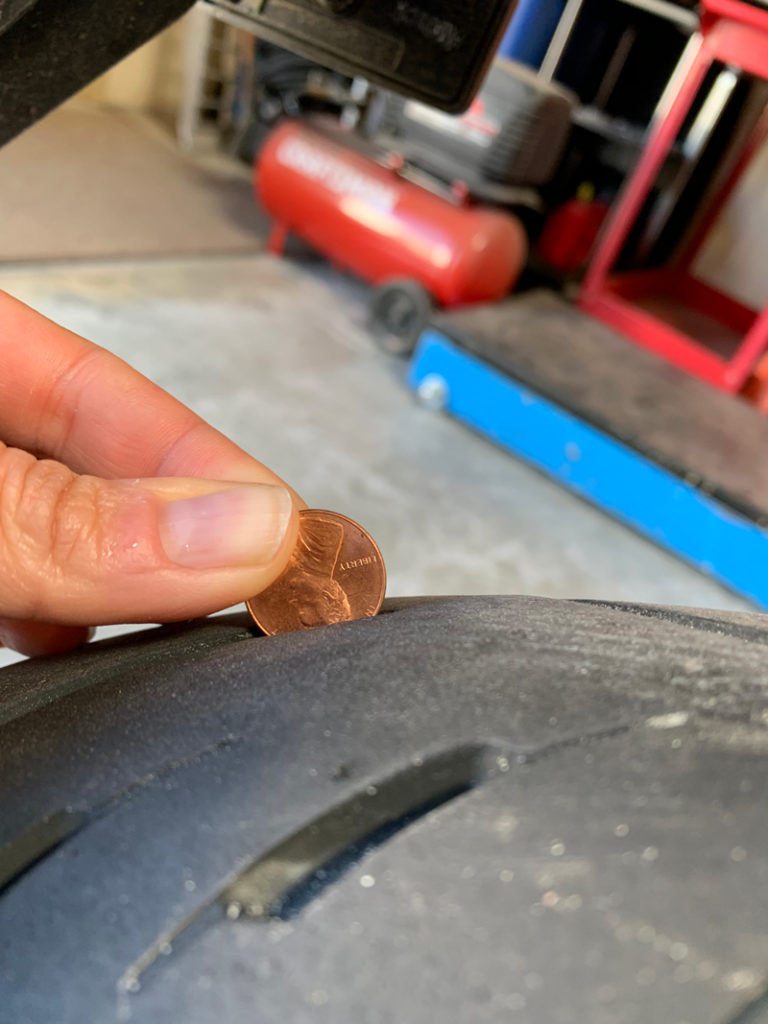 checking a tire with a penny