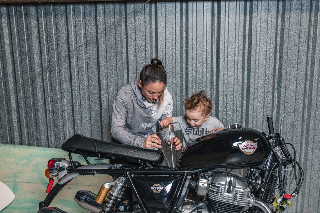 Melissa Paris working on Royal Enfield for Build Train Race with son Hawk.