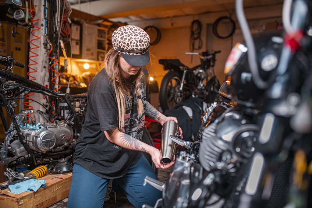 Lanakila Macnaughton working in the shop on her Royal Enfield flat tracker build. 