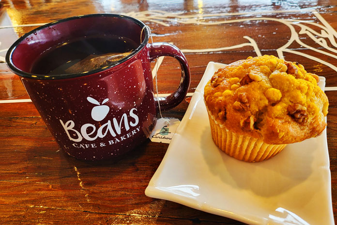 Beans coffee shop with mug and muffin

